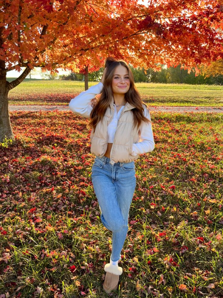 a woman standing in front of a tree