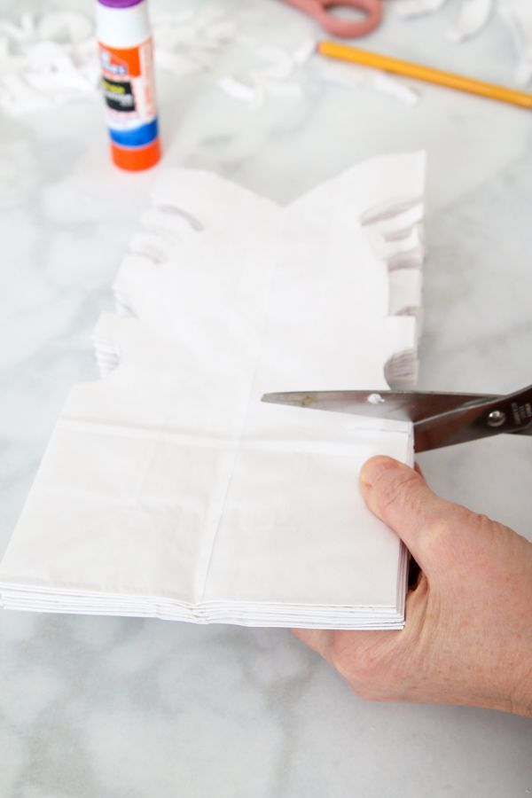 someone is cutting paper with scissors on a table