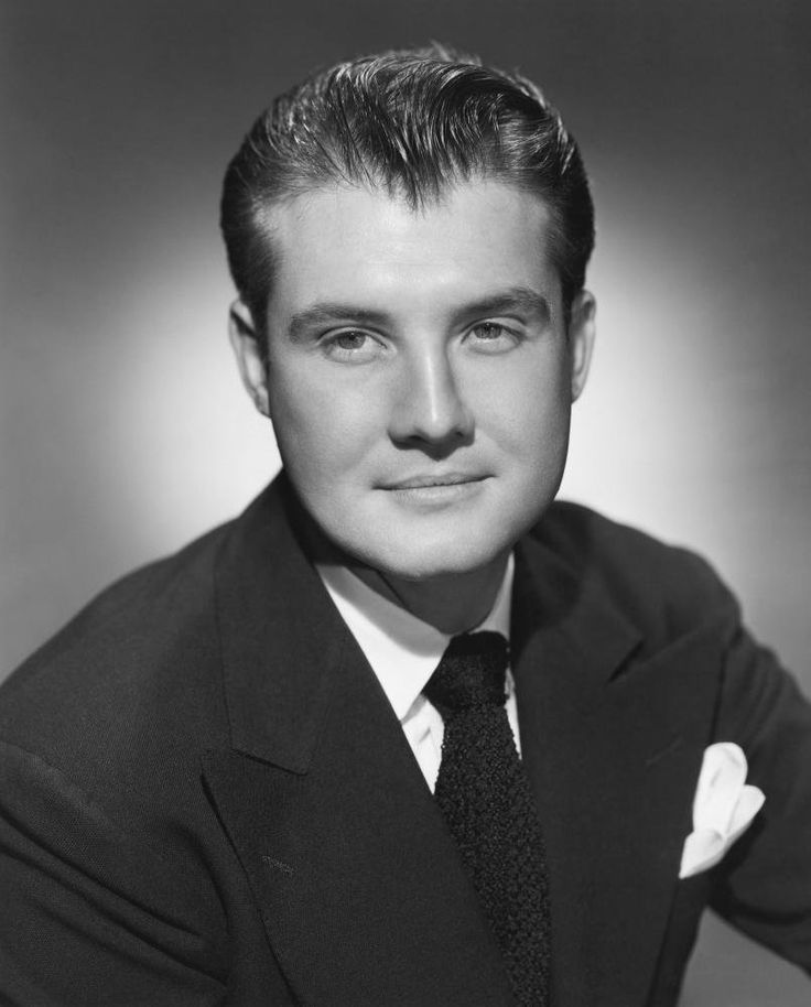 an old black and white photo of a man in a suit