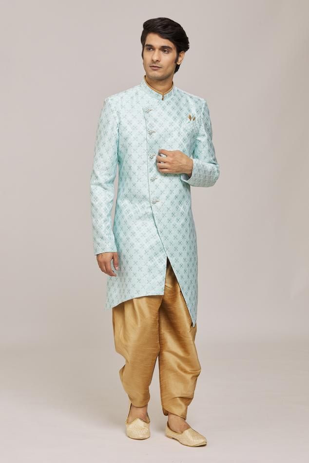 Firozi asymmetric sherwani with woven floral patterns. Comes with dhoti pant.
Components: 2
Pattern: Woven
Type Of Work: Floral
Neckline: Mandarin Collar
Sleeve Type: Full
Fabric: Sherwani: Mercury Jacquard Churidar: Silk Dupion
Color: Blue
Other Details: 
Embellished buttons
Closure:
Sherwani: Front button
Dhoti pant: Drawstring
Note: Pocket square worn by the model is not for sale
Occasion: Sangeet,Mehendi and Puja - Aza Fashions Traditional Fit Bollywood Sherwani With Pallu, Traditional Blue Sherwani For Navratri, Eid Traditional Bandhgala, Blue Traditional Wear With Naqshi Drape, Blue Traditional Wear With Naqshi, Traditional Fit Bandhgala For Eid, Eid Brocade Traditional Wear With Naqshi, Navratri Designer Sherwani With Naqshi Detailing, Designer Naqshi Sherwani For Navratri