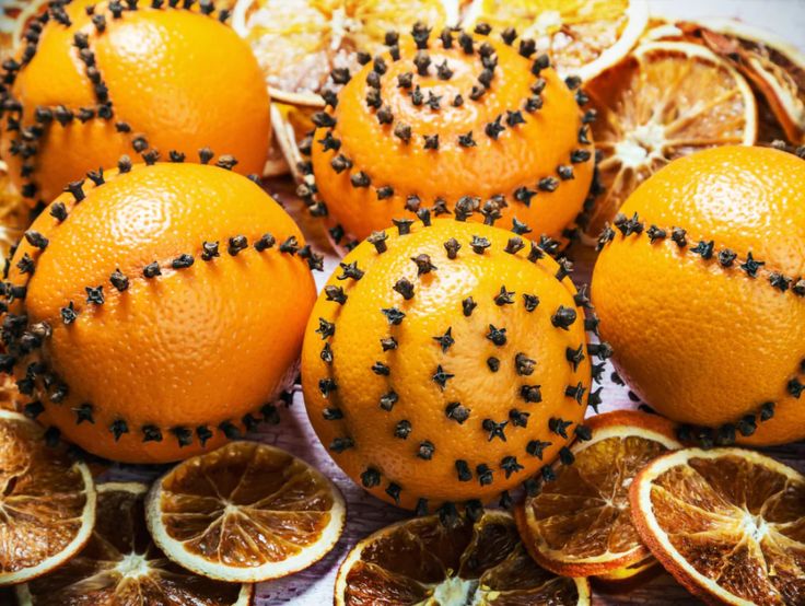 oranges with black seeds on them are arranged in a circle and surrounded by other fruit