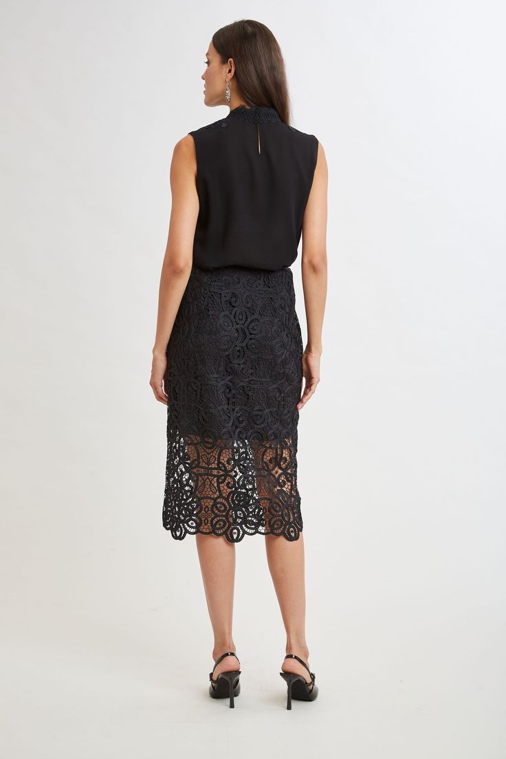 Reach for our Crochet Lace Midi Skirt for a sophisticated, fresh Fall look. The beautiful, scalloped hem is accented by the shorter lining for a glimpse of leg. Dress it down with a vegan leather jacket or cashmere or up with Satin. Limited Edition 50th Anniversary Collection Elie Tahari Exclusive Crochet Lace Midi Skirt 100% Polyester Runs true to Size Length From Waist to Hem: Back 30.25"L (approx. length for size 6) Model is 5'9" and wearing size 2 Dry Clean Only Imported Style #: E905R304 Chic Spring Bottoms With Cutwork Hem, Chic Bottoms With Cutwork Hem For Spring, Elegant Midi Length Bottoms With Lace Trim, Elegant Midi Pencil Skirt With Ruffles, Elegant Midi Pencil Skirt With Ruffle, Elegant Scalloped Lace Bottoms For Spring, Elegant Summer Skirt With Cutwork Hem, Elegant Fitted Skirt With Scalloped Lace, Elegant Midi Skirt With Lace Trim