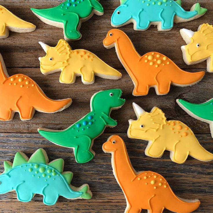 decorated cookies in the shape of dinosaurs