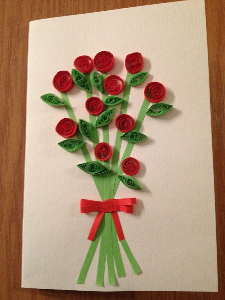 a card with flowers made out of paper