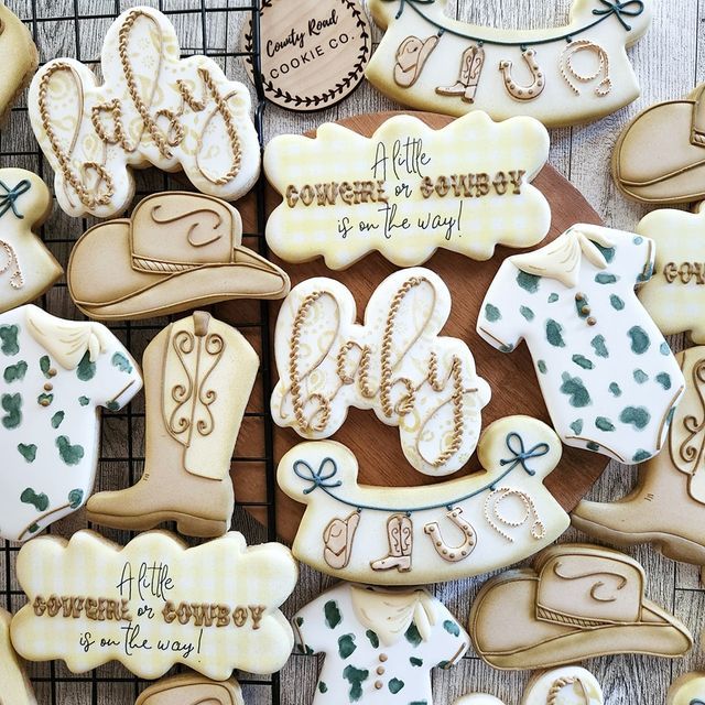 some cookies that are sitting on a cooling rack with the names of their babys