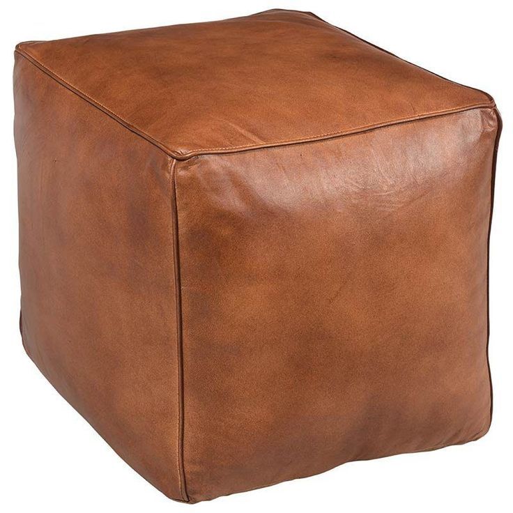 a brown leather cube ottoman sitting on top of a white floor