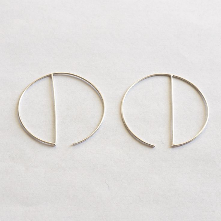 "A minimal, simple, and modern design hoop earring that would certainly get attention everywhere you go. Great for everyday wear or for a night on the town. This simple, modern hoop dangle earring is made from solid sterling silver and has a diameter of 43mm (1.7\"). + Material - Solid Sterling Silver or Yellow Gold Fill + Diameter - 43mm (1.7\") + Finish - Matte or Polished + Post Gauge - 20ga + Earring Priced for a Pair + Packaged in Kraft Box + These Earrings do Not come with Ear Backs About Modern Hoop Earrings With Simple Design, Minimalist Small Hoop Threader Earrings, Modern Everyday Circular Hoop Earrings, Minimalist Hoop Threader Earrings, Minimalist Open Circle Hoop Earrings, Minimalist Diamond Hoop Earrings, Minimalist Geometric Hoop Earrings With Ear Wire, Modern Geometric Hoop Earrings With Ear Wire, Minimalist Open Circle Hoop Earrings For Everyday