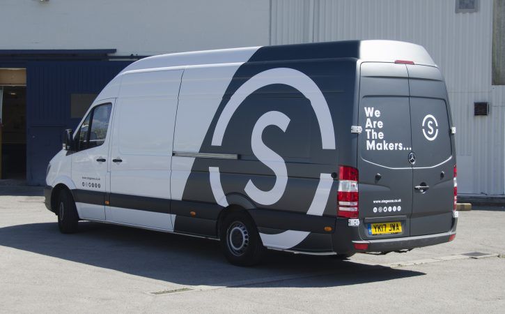 a van parked in front of a building