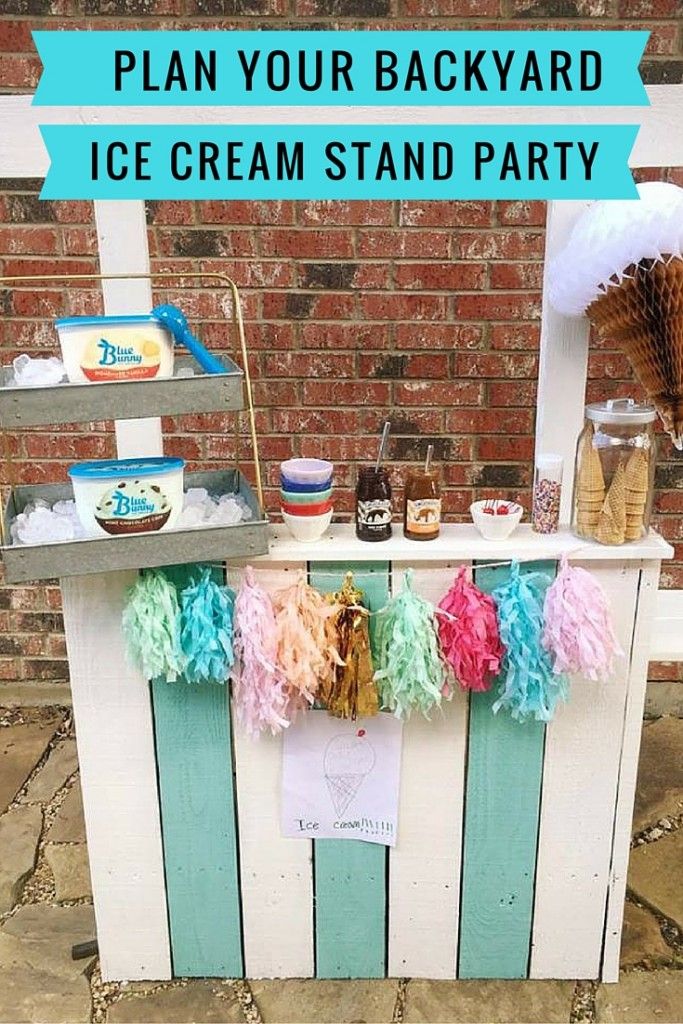 an ice cream stand is decorated with pom - poms and streamers for a party