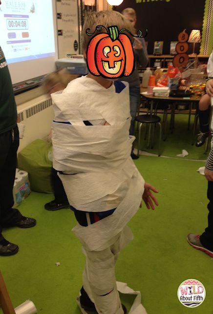 a man dressed up as a pumpkin with toilet paper wrapped around his head and legs