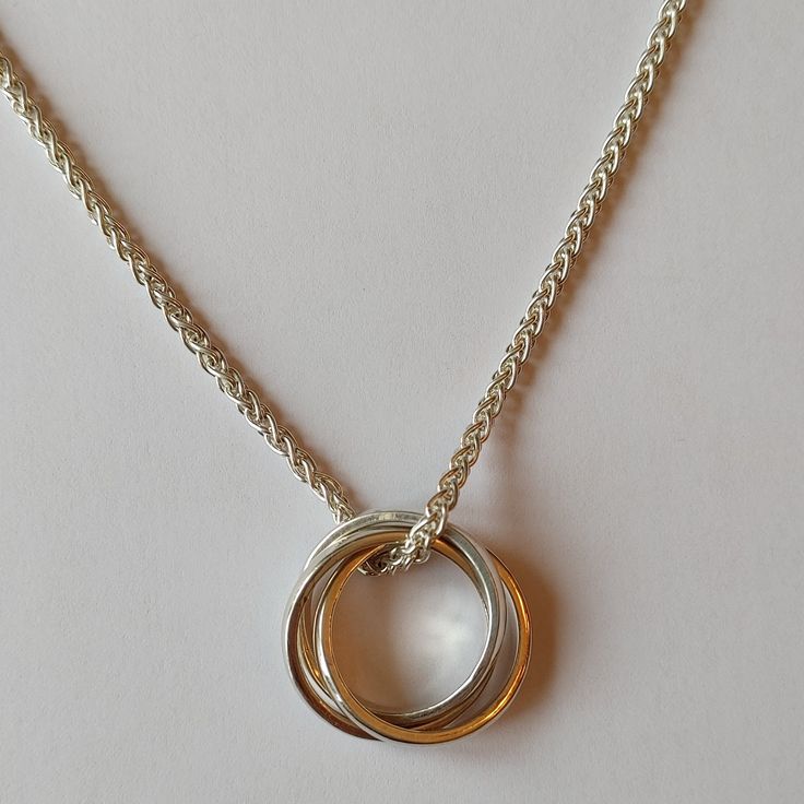 This timeless Interlocking Circle Necklace is crafted from sterling silver for a captivating look. Its two interlocking circles represent the perfect balance between strength and beauty, making it an ideal accessory for any occasion. ITEM INFORMATION: Pendant Measurement(s): Approx. 20 mm (0.78 inches) W X Approx. 22 mm (0.86 inches) L Pendant Material: Sterling Silver Necklace Length: 18" Wheat Sterling Silver Chain For inquiries, please email us at info@suttonsmithworks.com This item is availa Interlocking Circle Necklace, Circle Necklace, Custom Jewelry Design, Custom Engagement Ring, Sterling Silver Chain, Sterling Silver Necklace, Necklace Length, Wedding Ring Bands, Sterling Silver Chains