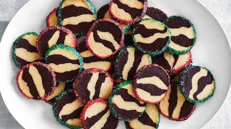 a white plate topped with cookies covered in zebra print