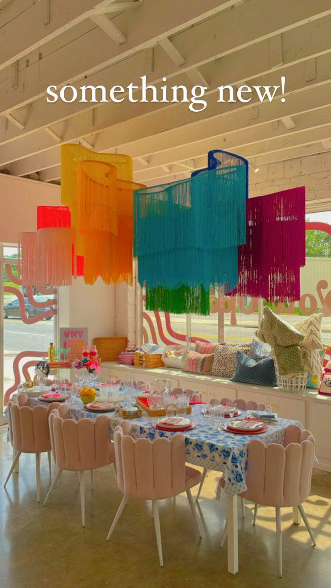 Multi colored fringe chandelier above dining table for store decor Diy Bohemian Chandelier, Art Deco Wall Hanging, Fringe Home Decor, Colorful Table Decor Wedding, Fringe Chandelier Wedding, Furniture With Fringe, 70s Glam Decor, Fringe Party Decor, Maximalist Party Decor