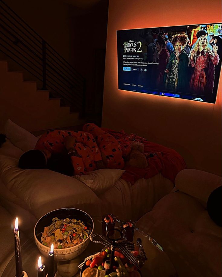 a living room filled with furniture and a flat screen tv mounted to the side of a wall