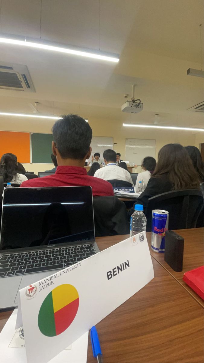 a group of people sitting in front of laptops on top of a wooden table