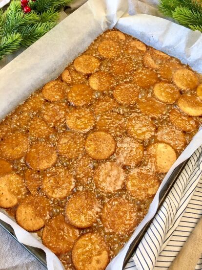 a pan filled with baked goods on top of a table next to christmas wreaths