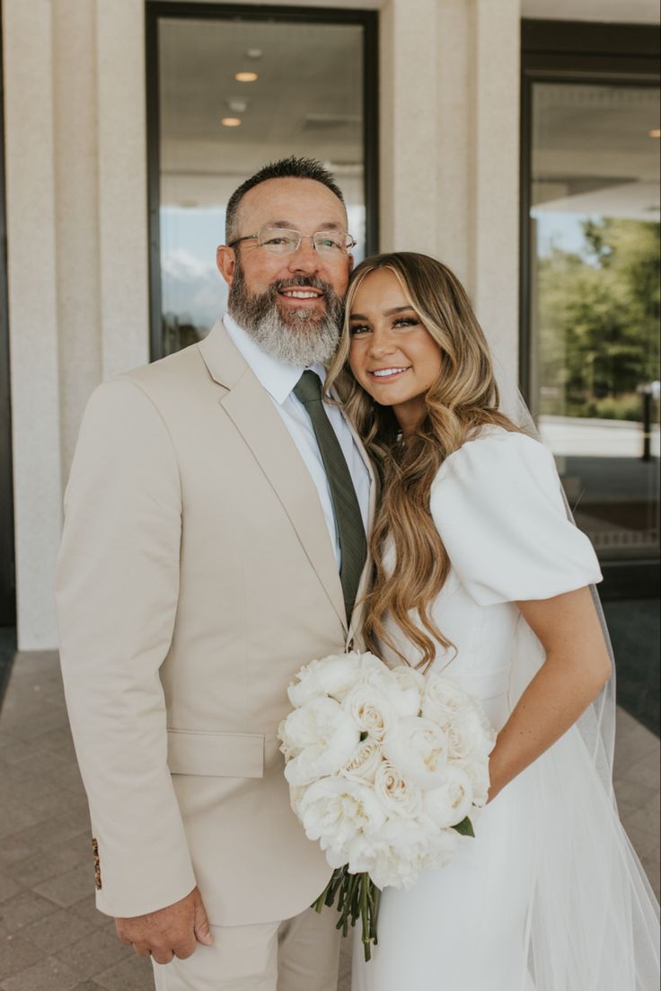 a bride and groom posing for a photo