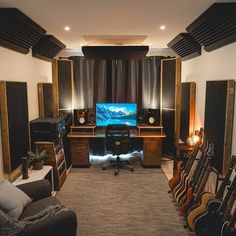 a living room filled with lots of furniture and musical equipment on top of carpeted flooring