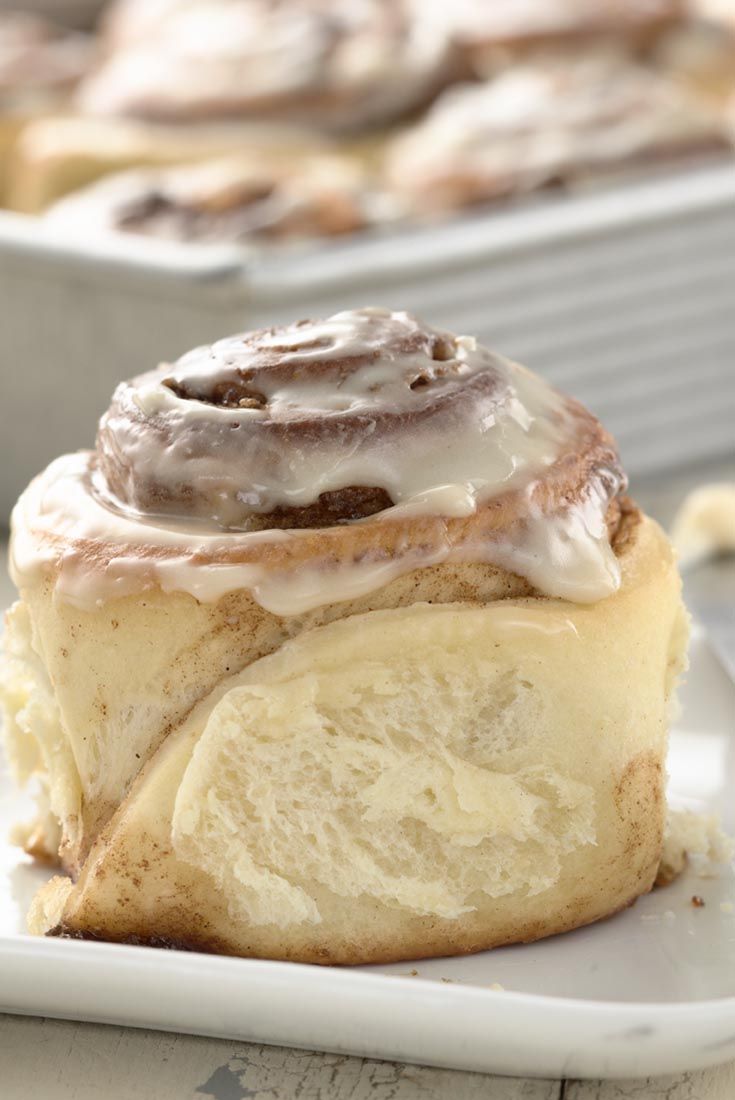 a pastry with frosting sitting on top of a white plate