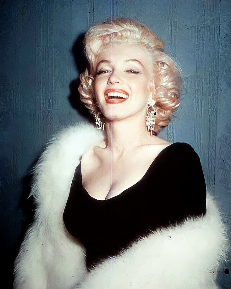 marilyn monroe in black and white fur stoler with large earrings on her left ear