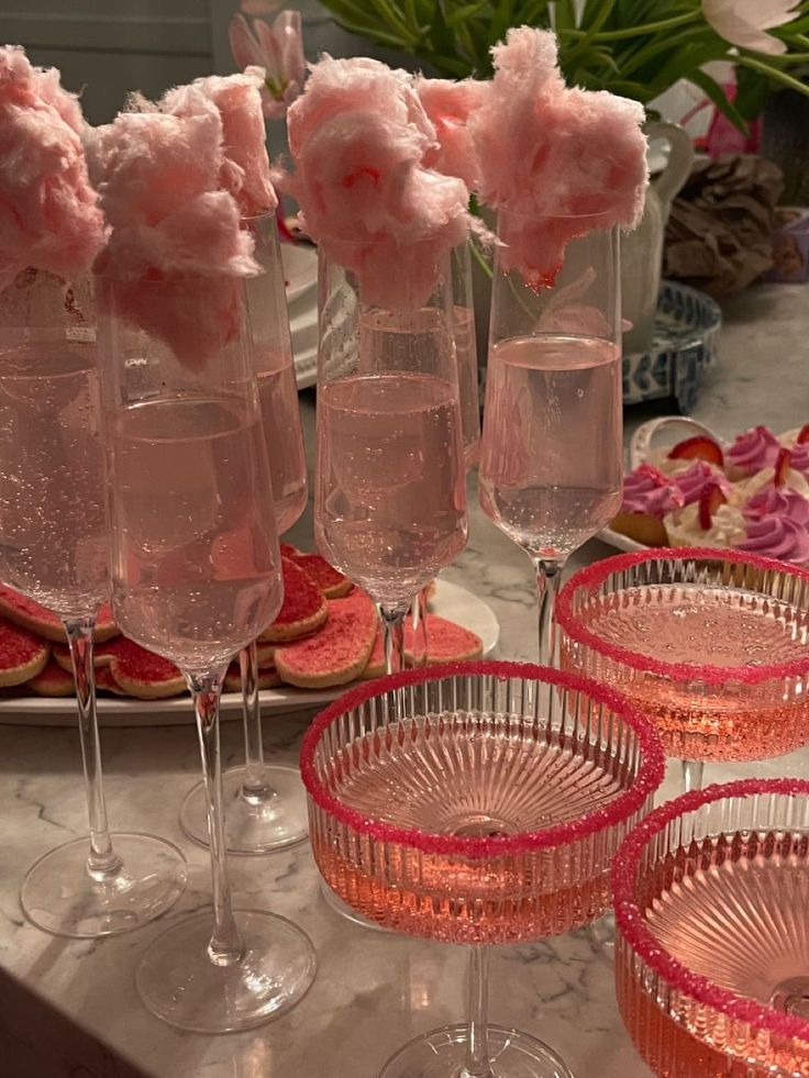 there are many pink glasses on the table