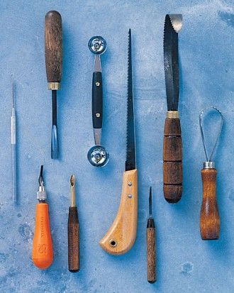 an assortment of tools are displayed on a blue surface