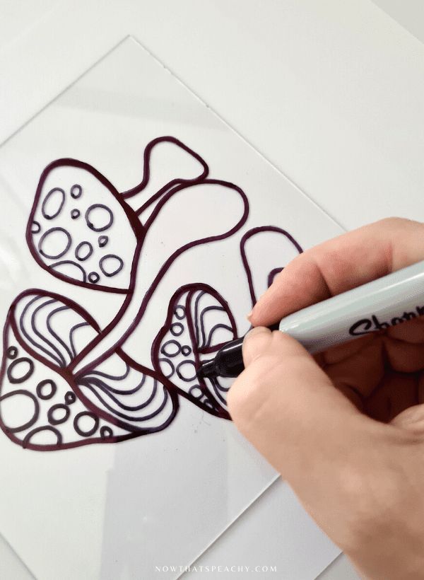 a person is drawing on a piece of paper