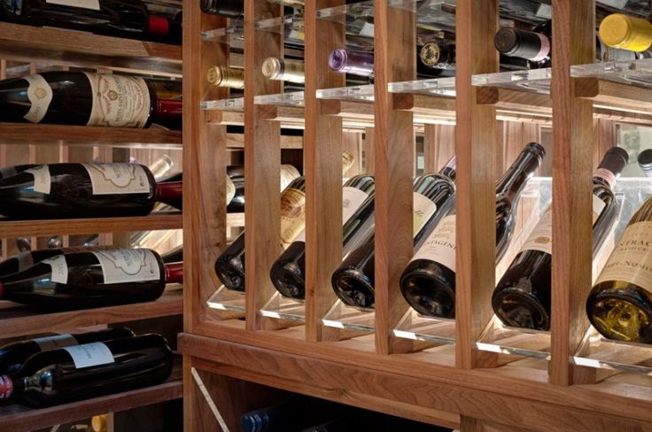 a wooden wine rack filled with lots of bottles