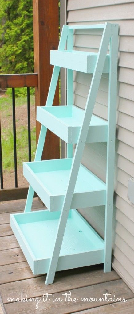 a blue shelf sitting on top of a wooden deck