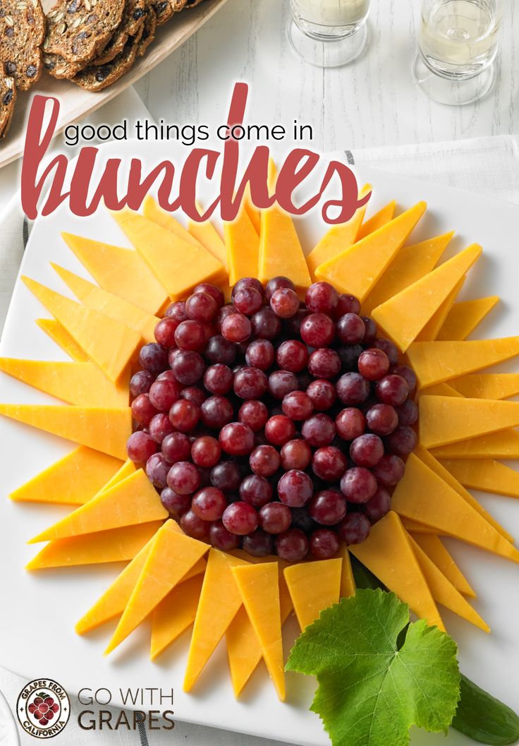 a sunflower made out of grapes on top of a white plate with the words good things come in hanches