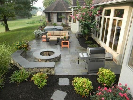 an outdoor patio with seating and fire pit