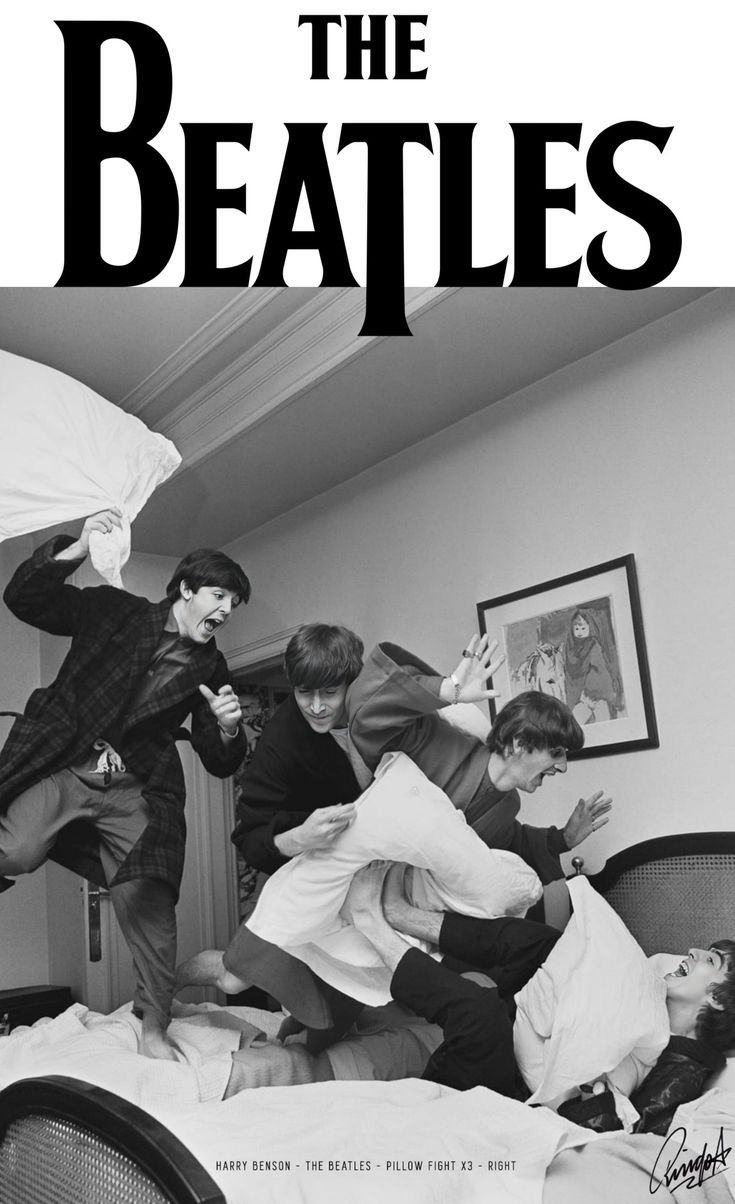 black and white photograph of the beatles in bed with one man jumping up into the air