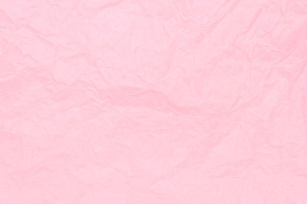 a pink paper textured background with some folds