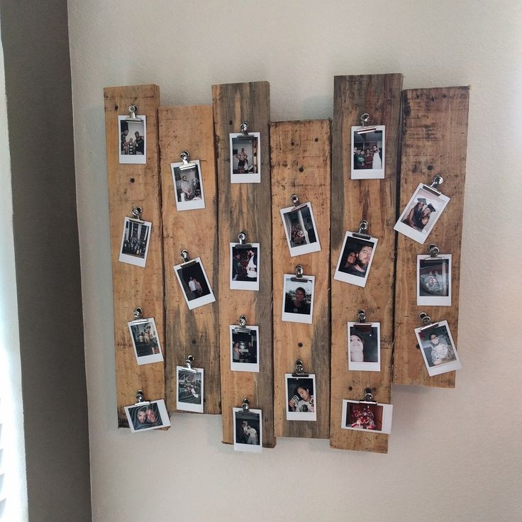 an old wooden board with pictures hanging on it