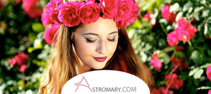 a woman with flowers in her hair holding a sign