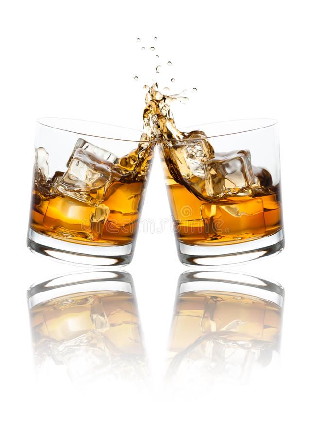 two glasses of whiskey with ice cubes splashing out the top on white background