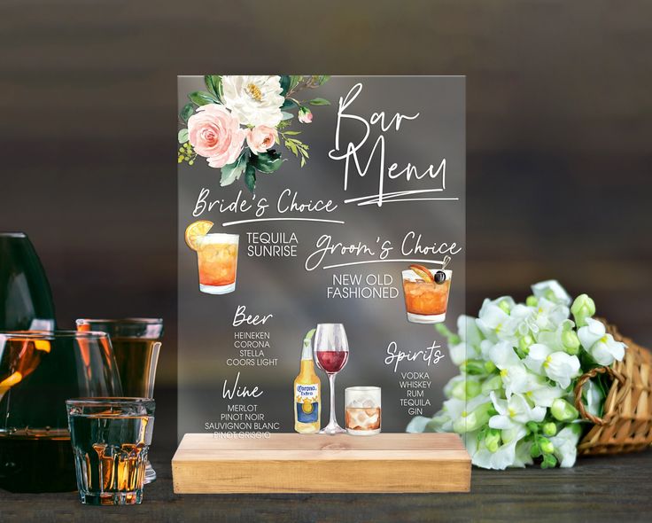 a menu board with drinks and flowers on it