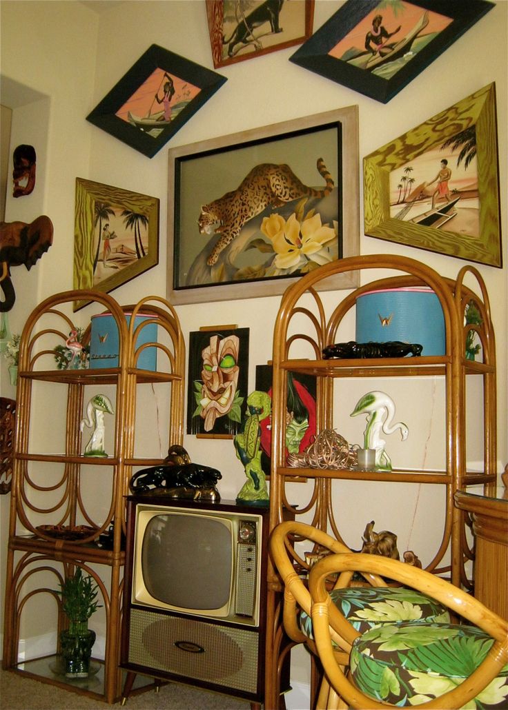 a living room filled with furniture and pictures on the wall above it's tv