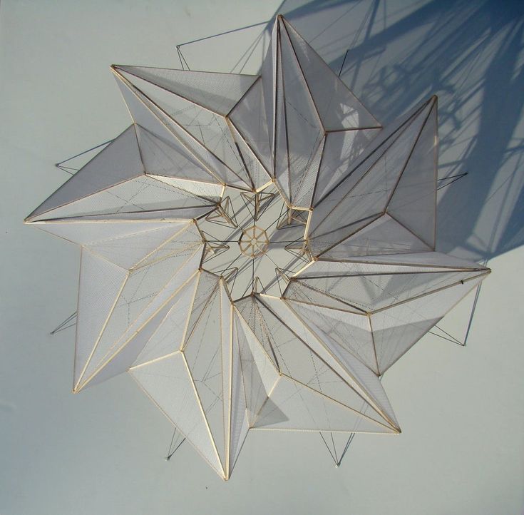 an overhead view of a white object with many lines and shapes in the shape of a star