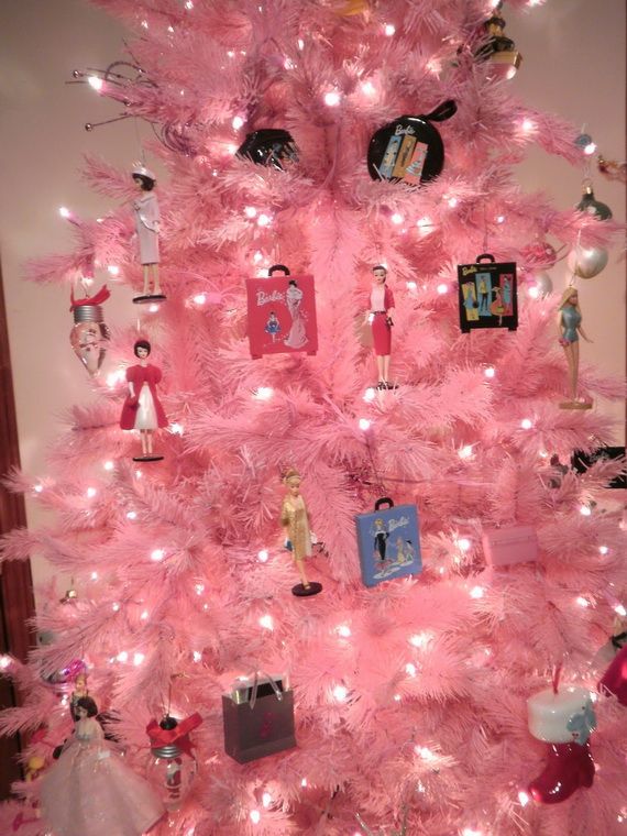 a pink christmas tree decorated with barbie dolls