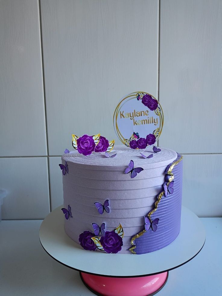 a purple and white cake with butterflies on it