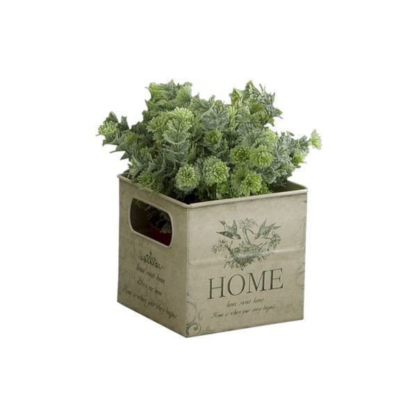 a planter filled with green plants sitting on top of a white tablecloth covered box