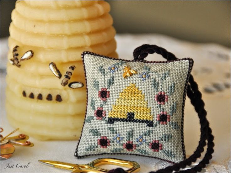 a small purse sitting on top of a table next to a beehive and honey comb