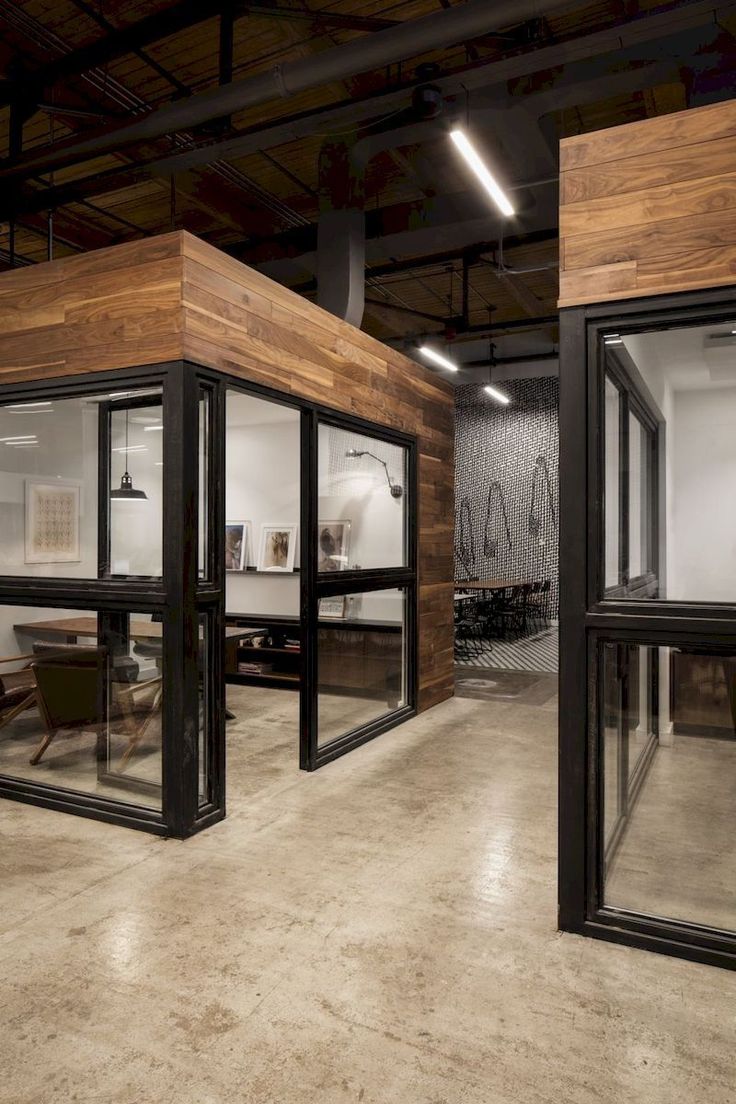 an empty office with wooden walls and glass doors