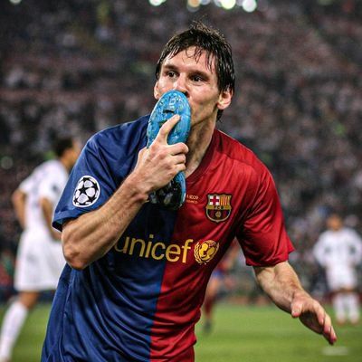 a soccer player holding a green object in his right hand while standing on a field