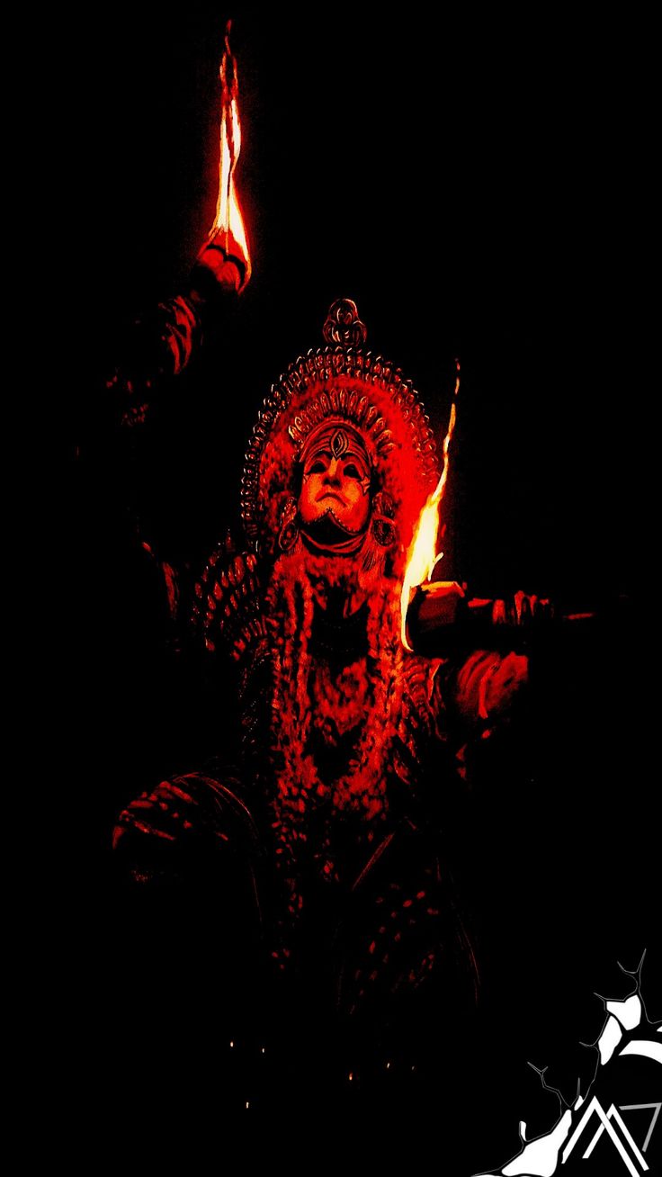 an image of a person holding torches in the dark