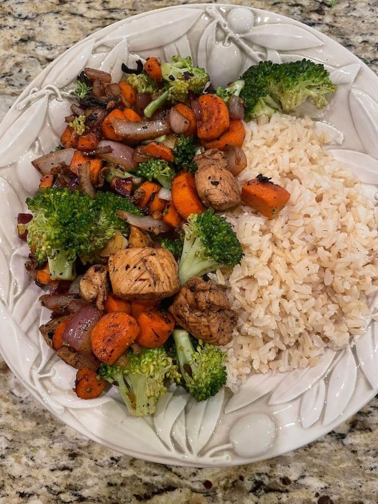 a white plate topped with rice and veggies