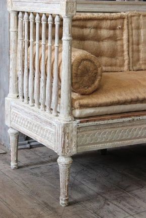 an old white crib sitting on top of a wooden floor