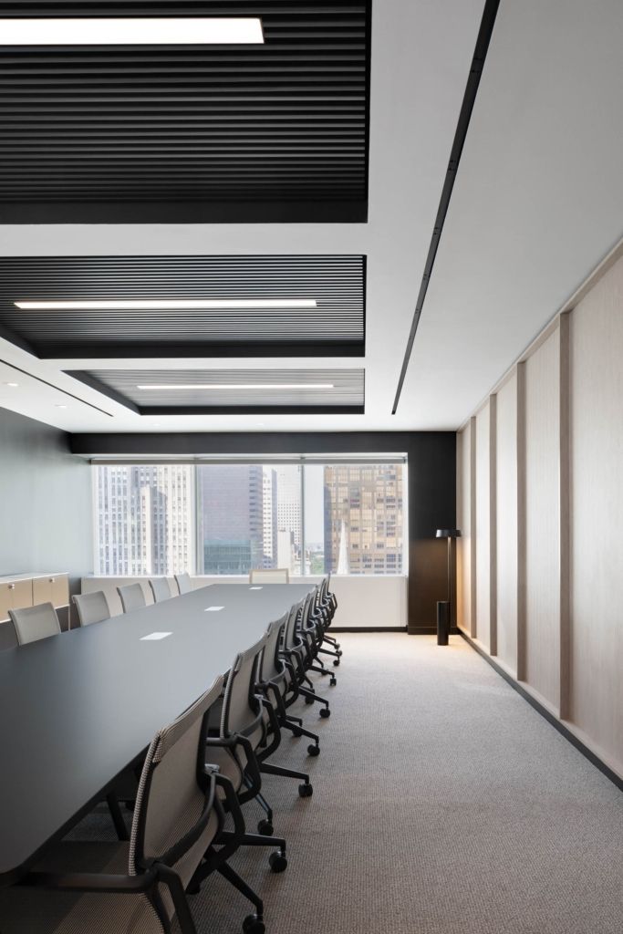 an empty conference room with long tables and chairs