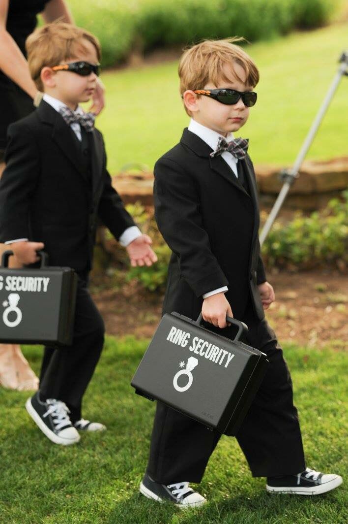 two young boys dressed in suits and sunglasses holding briefcases with the number 8 on them